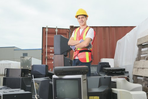 Workers handling bulky household items during clearance